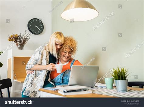 Lesbian Couple Laughing Hugging While Using Stock Photo Shutterstock