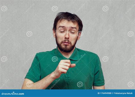 Man Making A Funny Face While Coughing Into His Hand Stock Photo