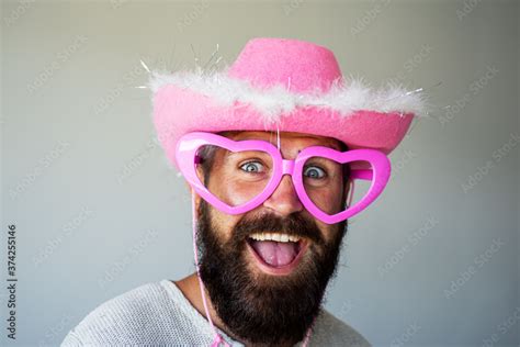 Happy man smile face. Handsome smiling young guy with funny pink glasses. Positive human facial ...