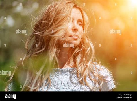 Blond Garden Portrait Of A Blonde In The Park Happy Woman With Long Blond Hair In A Blue Dress