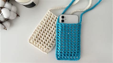 Two Cell Phones Are Next To A Crocheted Bag And A Cup Of Coffee