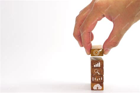 Premium Photo Hand Of Businessman Holding A Wooden Block With A