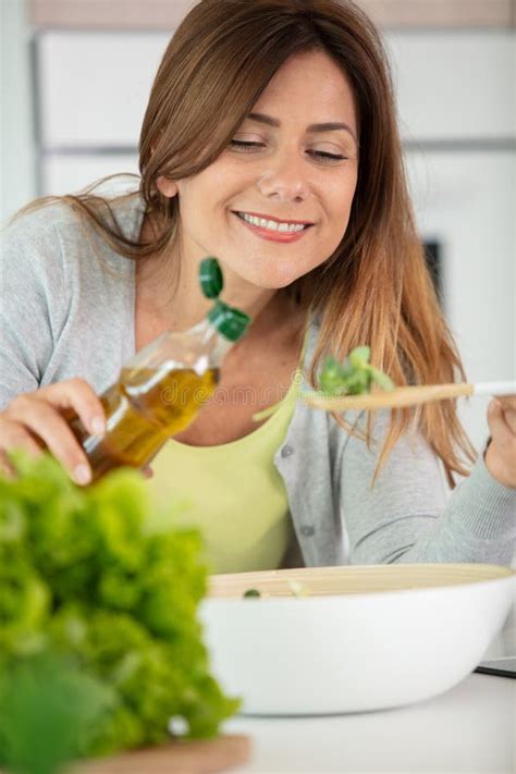 Woman Pouring Olive Oil In To Salad Stock Photo Image Of Bottle