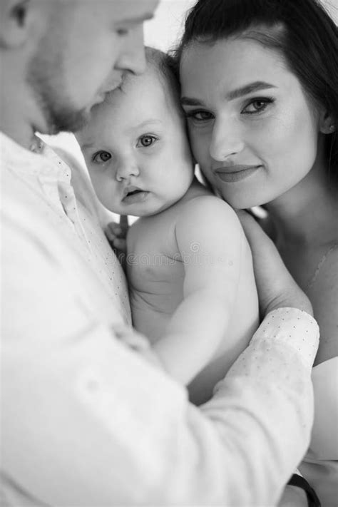 Naked Baby Girl Being Embraced By Loving Parents Indoors Stock Photo Image Of Daughter