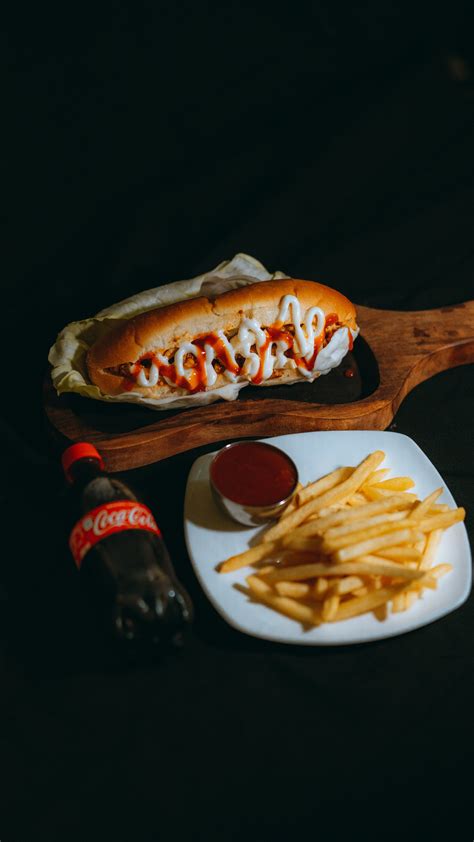 A Person Dipping French Fries on the Ketchup · Free Stock Photo