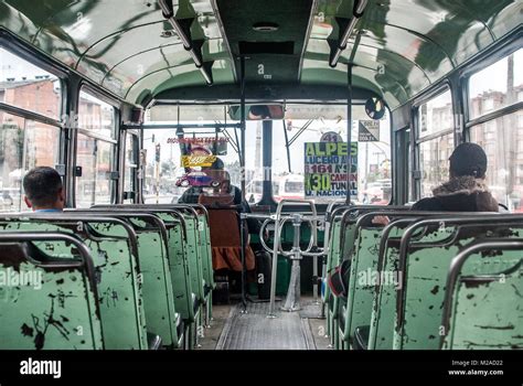 The interior of an old city bus with chipped green paint in Bogota ...