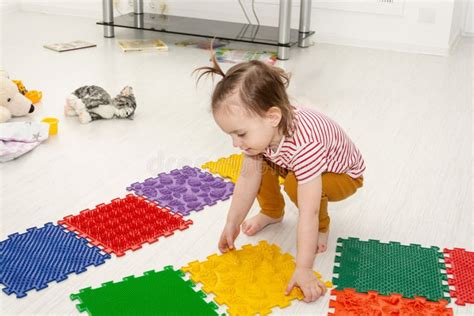 Little Caucasian Smiling Toddler Girl Play with Baby Massage Puzzle Floor Mats with Colorful ...