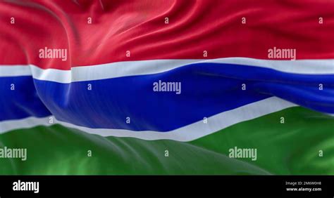 Close Up View Of The Gambia National Flag Waving In The Wind Stock