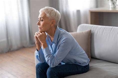 Premium Photo Upset Mature Woman Thinking About Issues At Home Interior