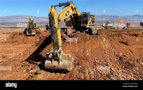 Excavators Working On Huge Mining Site Loading The Trucks Trucks