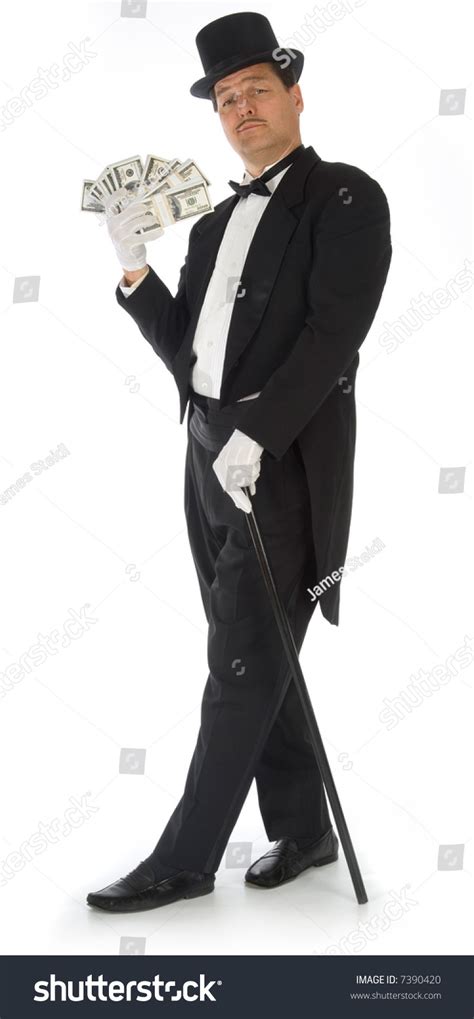 Man In Tuxedo Top Hat And Cane Fanning Himself With Stacks Of Money