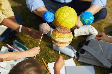 Premium Photo Close Up Of Group Of Children Holding Model Planets