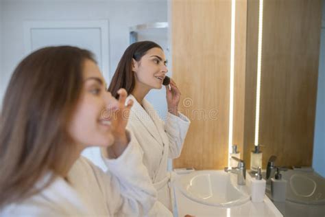 Two Pretty Girls Doing Make Up Near The Mirror Stock Photo Image Of