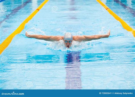 Dynamic and Fit Swimmer in Cap Breathing Performing the Butterfly Stroke Stock Image - Image of ...