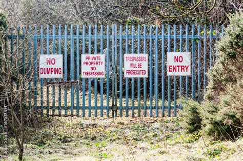 Signs On A Security Gate Warning No Dumping Private Property No