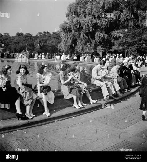 Group of people sitting around Mall Fountain, Central Park, New York