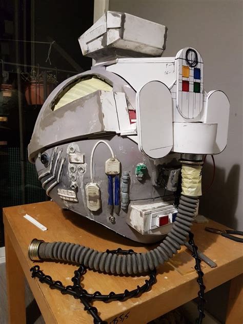 A Helmet That Is Sitting On Top Of A Wooden Table With Wires Attached To It