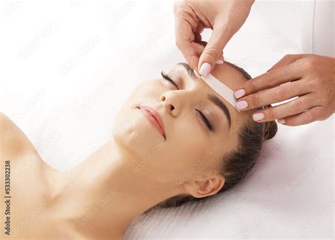 Professional Worker Is Removing Hair From Beautiful Female Face With Hot Wax Girl Has A Beauty