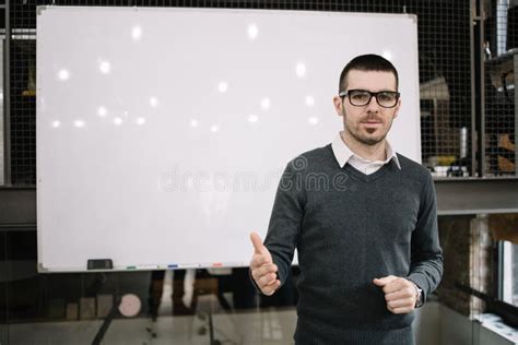 Portrait Of Businessman Standing In Front Of A Whiteboard In Office