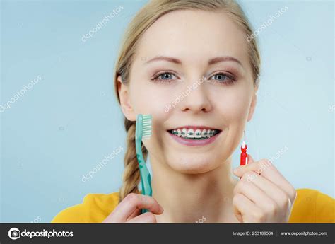 Girl With Teeth Braces Using Interdental And Traditional Brush Stock