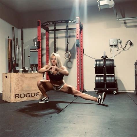 a woman squats on one leg in a crossfit gym