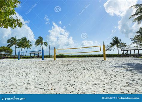 A Beach Volleyball Net On A Sunny Beach With Palm Trees Stock Photo