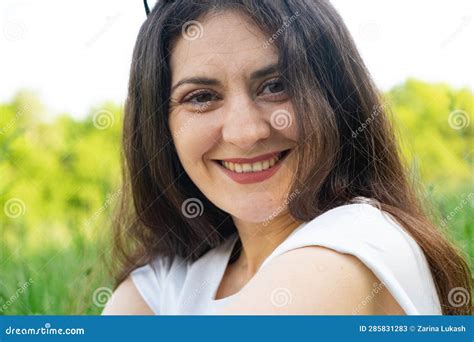 Portrait Of A Year Old Brunette Woman Looking At The Camera Smiling
