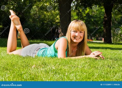 Young Smiling Girl Lies on Grass Stock Image - Image of beautiful ...