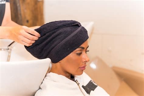Free Photo A Brunette Woman Sitting In The Beauty Salon Drying Her Hair