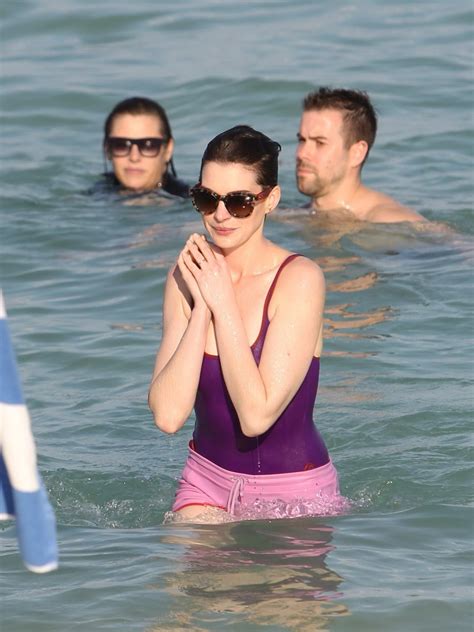 Anne Hathaway Wearing Wet Purple See Through Swimsuit And Shorts At The Beach In Porn Pictures