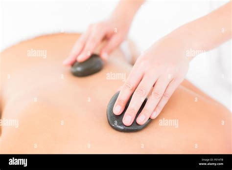 Woman Enjoying A Hot Stone Massage Stock Photo Alamy