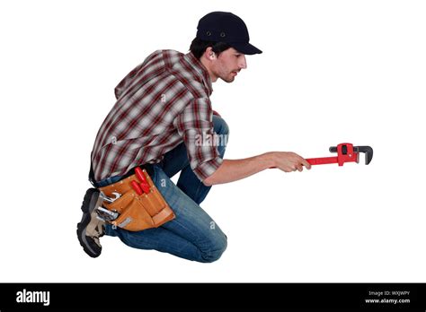 Plumber using adjustable wrench Stock Photo - Alamy