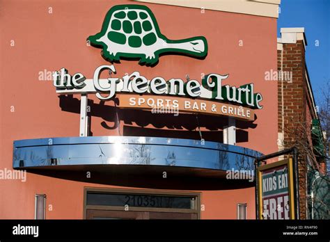 A logo sign outside of a The Green Turtle restaurant location in Dulles ...