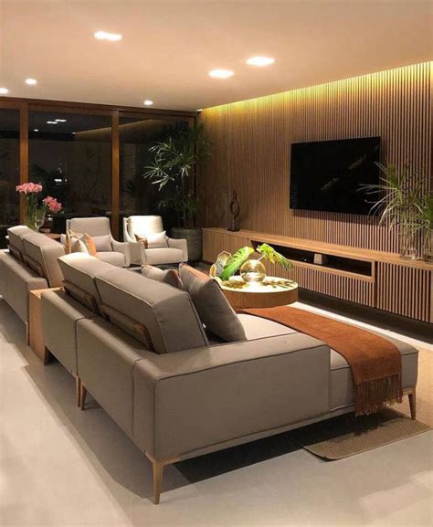 A Living Room With Couches And A Television On The Wall In Front Of It