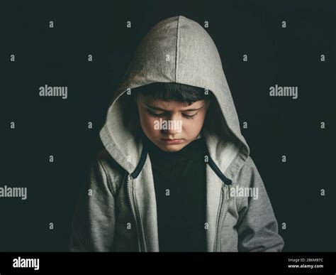 Sad boy on black background Stock Photo - Alamy