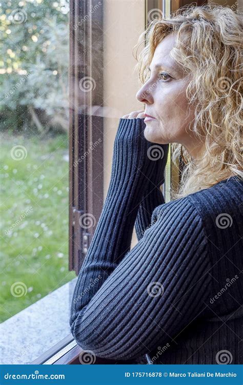 Italian Blonde Woman Forced Into House By Quarantine Due To Coronavirus Covid 19 Looks At The