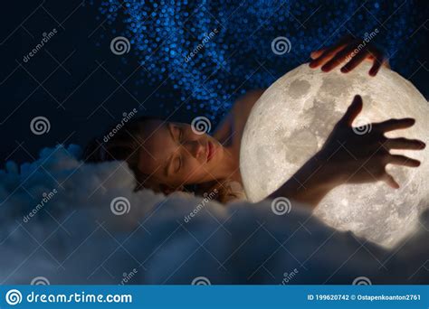 Close Up View Of Tender Naked Beautiful Woman Lies On The Soft Clouds And Hugs The Bright Moon