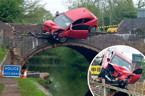 Incredible Moment Car Dangles Over Canal After Crashing Into Wall The