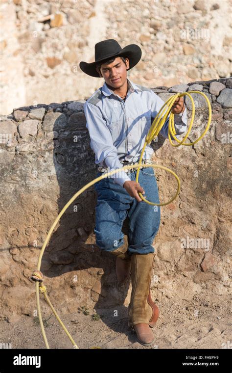 A Mexican Charro Or Cowboy Poses In Cowboy Hat And Lasso At A Hacienda