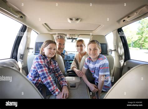 Happy family inside car leaving for vacation Stock Photo - Alamy