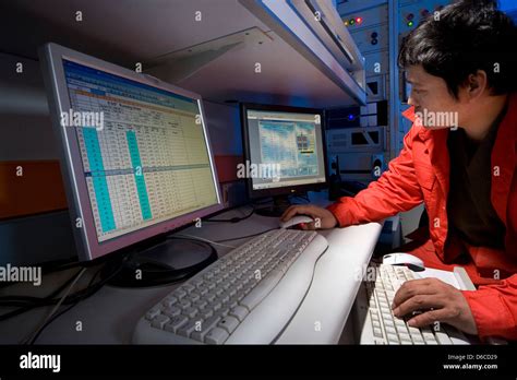 Mud logging geologist in mud log control room viewing results from