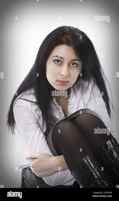 Brunette Girl Sitting On The Floor And Hugging Her Knees Moscow