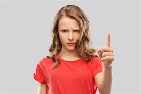 Premium Photo Angry Frowning Teenage Girl Pointing Finger Up