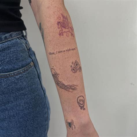 A Woman S Arm With Tattoos On It And A Skull In The Middle Is Shown