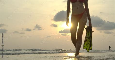 Sexy Hot Woman In Red Bikini Walks Along Ocean Shore At Senset Steadicam Slow Motion Shot