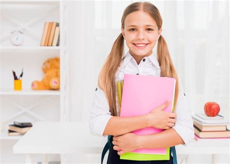 Joyeuse Fille Souriante Avec Des Livres Photo Gratuite