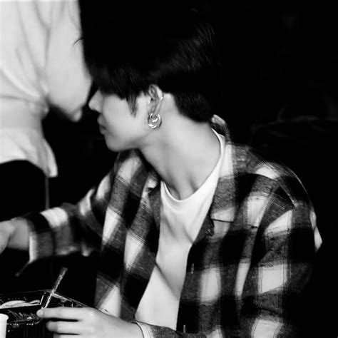 Black And White Photograph Of A Person Sitting At A Table