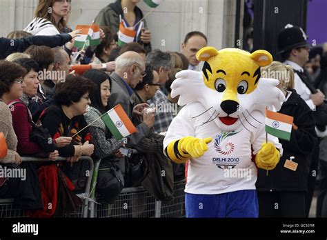 Shera The Mascot Waves A Flag During The Launch Of The XIX Commonwealth