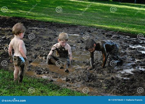 Three Boys Playing In Mud Stock Image Image Of Three 137073643