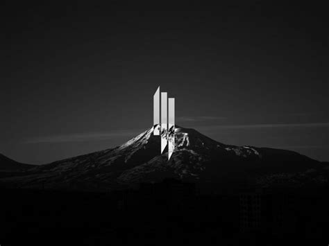 two tall buildings sitting on top of a mountain under a dark sky with ...